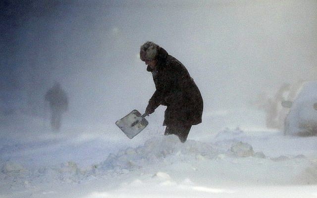 A woman shovels a path to her car in the East Boston neighborhood of Boston, January 4, 2018, as a huge winter storm roared up the East Coast with hurricane-force winds, heavy snow and coastal flooding. (AP Photo/Michael Dwyer) A woman shovels a path to her car in the East Boston neighborhood of Boston, January 4, 2018, as a huge winter storm roared up the East Coast with hurricane-force winds, heavy snow and coastal flooding. (AP Photo/Michael Dwyer)