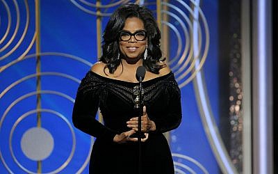 This image released by NBC shows Oprah Winfrey accepting the Cecil B. DeMille Award at the 75th Annual Golden Globe Awards in Beverly Hills, Calif., on Sunday, January 7, 2018. (Paul Drinkwater/NBC via AP)