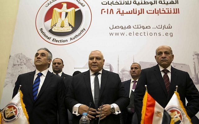 Lasheen Ibrahim, head of the National Electoral Commission, which is in charge of supervising the 2018 Egyptian presidential election, center, and members of the commission prepare to give a press conference at the commission headquarters in Cairo, Egypt, on January 8, 2018. (AP Photo/Amr Nabil)