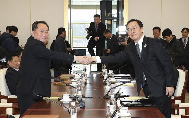 South Korean Unification Minister Cho Myoung-gyon, right, shakes hands with the head of North Korean delegation Ri Son Gwon before their meeting at the Panmunjom in the Demilitarized Zone in Paju, South Korea, Tuesday, January 9, 2018. (Korea Pool/Yonhap via AP) South Korean Unification Minister Cho Myoung-gyon, right, shakes hands with the head of North Korean delegation Ri Son Gwon before their meeting at the Panmunjom in the Demilitarized Zone in Paju, South Korea, Tuesday, January 9, 2018. (Korea Pool/Yonhap via AP)
