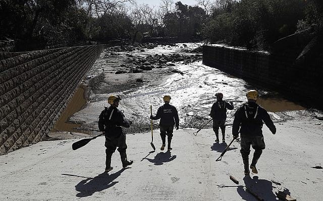 Members of the Los Angeles County Fire Department Search and Rescue crew walk toward flooded waters in Montecito, California, on Wednesday, January 10, 2018. (AP/Marcio Jose Sanchez) Members of the Los Angeles County Fire Department Search and Rescue crew walk toward flooded waters in Montecito, California, on Wednesday, January 10, 2018. (AP/Marcio Jose Sanchez)