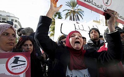 Family members of Tunisians who died in the revolution seven years ago, stage a protest in Tunis, Tunisia, January 13, 2018. (AP Photo/Hassene Dridi)