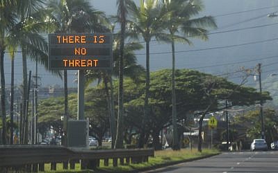 This January 13, 2018, photo provided by Jhune Liwanag shows a highway median sign broadcasting a message of "There is no threat" in Kaneohe, Hawaii. (Jhune Liwanag via The AP)