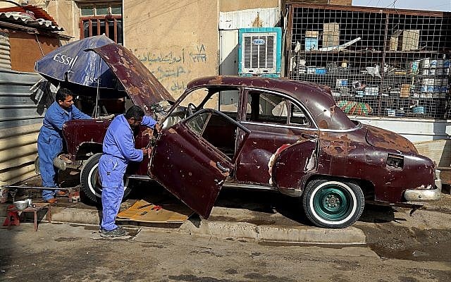 In this Thursday, January 11, 2018 photo, mechanics work on Saad al-Nuaimi's badly damaged 1952 Chevrolet, that he acquired from Salahuddin province, where the Islamic State group was driven out in 2015, in Baghdad, Iraq. (AP Photo/Karim Kadim) In this Thursday, January 11, 2018 photo, mechanics work on Saad al-Nuaimi's badly damaged 1952 Chevrolet, that he acquired from Salahuddin province, where the Islamic State group was driven out in 2015, in Baghdad, Iraq. (AP Photo/Karim Kadim)