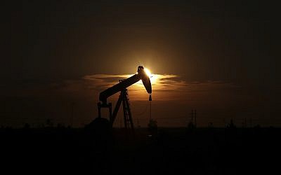 This June 27, 2017, file photo shows an oil rig at sunset in Midland, Texas. (Steve Gonzales/Houston Chronicle via AP, File)
