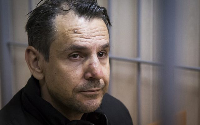 In this file photo taken on Tuesday, Oct. 24, 2017, Boris Grits, 48, who holds Russian and Israeli citizenship, sits in a cage in a courtroom in Moscow, Russia. (AP Photo/Alexander Zemlianichenko)