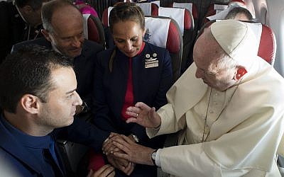 Pope Francis marries flight attendants Carlos Ciuffardi, left, and Paola Podest, center, during a flight from Santiago, Chile, to Iquique, Chile, January 18, 2018. (L'Osservatore Romano Vatican Media/Pool Photo via AP)