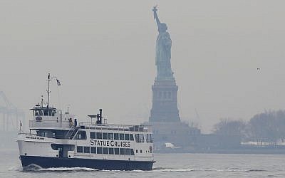 A Statue of Liberty and Ellis Island tour boat passes by the Statue of Liberty after dropping passengers off there on January 22, 2018, in New York. (AP Photo/Kathy Willens)