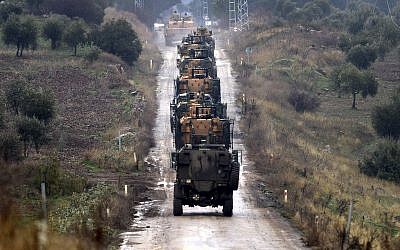 A convoy of Turkish Army armored personnel carriers led by a tank are driven toward the border with Syria, in the outskirts of Hassa, Turkey, Tuesday, January 23, 2018. (Ibrahim Mase/DHA-Depo Photos via AP)