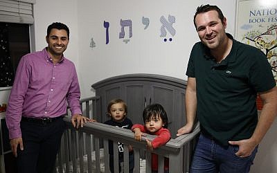 Elad Dvash-Banks, left, and his partner, Andrew, pose for photos with their twin sons, Ethan, center right, and Aiden in their apartment Tuesday, Jan. 23, 2018, in Los Angeles. (AP Photo/Jae C. Hong) Elad Dvash-Banks, left, and his partner, Andrew, pose for photos with their twin sons, Ethan, center right, and Aiden in their apartment Tuesday, Jan. 23, 2018, in Los Angeles. (AP Photo/Jae C. Hong)
