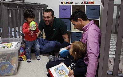 Elad Dvash-Banks, right, and his partner, Andrew, play with their twin sons, Ethan, left, and Aiden in their apartment Tuesday, Jan. 23, 2018, in Los Angeles. (AP Photo/Jae C. Hong) Elad Dvash-Banks, right, and his partner, Andrew, play with their twin sons, Ethan, left, and Aiden in their apartment Tuesday, Jan. 23, 2018, in Los Angeles. (AP Photo/Jae C. Hong)