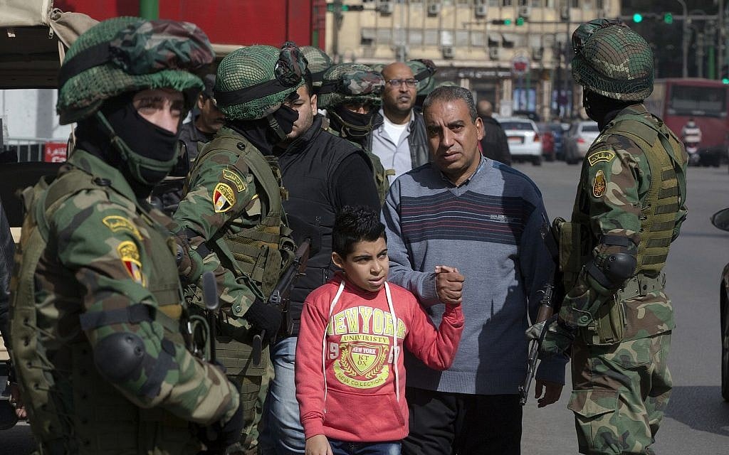 In this Jan. 24, 2018 file photo, people walk by special forces soldiers guard in front of the National Election Authority, which is in charge of supervising the 2018 presidential election, in Cairo, Egypt. (AP Photo/Amr Nabil, File) In this Jan. 24, 2018 file photo, people walk by special forces soldiers guard in front of the National Election Authority, which is in charge of supervising the 2018 presidential election, in Cairo, Egypt. (AP Photo/Amr Nabil, File)