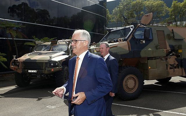 Australia Prime Minister Malcolm Turnbull walks in front of military trucks during a visit to Thales Underwater Systems in Sydney on January 29, 2018. (Daniel Munoz/AAP Image via AP) Australia Prime Minister Malcolm Turnbull walks in front of military trucks during a visit to Thales Underwater Systems in Sydney on January 29, 2018. (Daniel Munoz/AAP Image via AP)