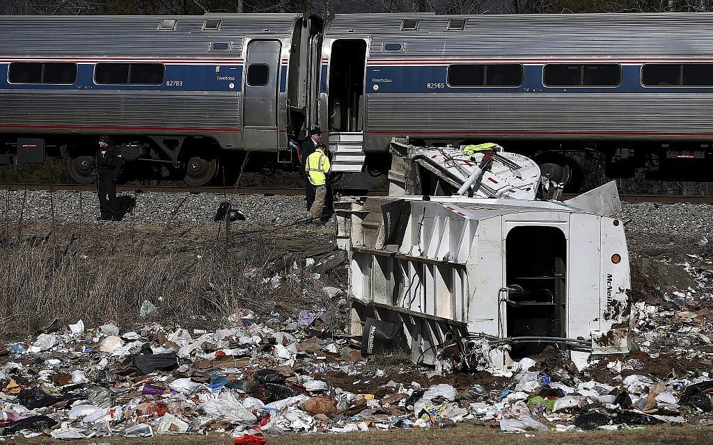 Emergency personnel work at the scene of a train crash involving a garbage truck in Crozet, Va., on Wednesday, Jan. 31, 2018. An Amtrak passenger train carrying dozens of GOP lawmakers to a Republican retreat in West Virginia struck a garbage truck south of Charlottesville, Va. No lawmakers were believed injured. (Zack Wajsgrasu/The Daily Progress via AP)