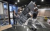 Elizabeth Tinker and Noah Smalls install an American Friends Service Committee exhibit at the African American Museum in Philadelphia, Tuesday, January 10, 2017. (AP/Matt Rourke)