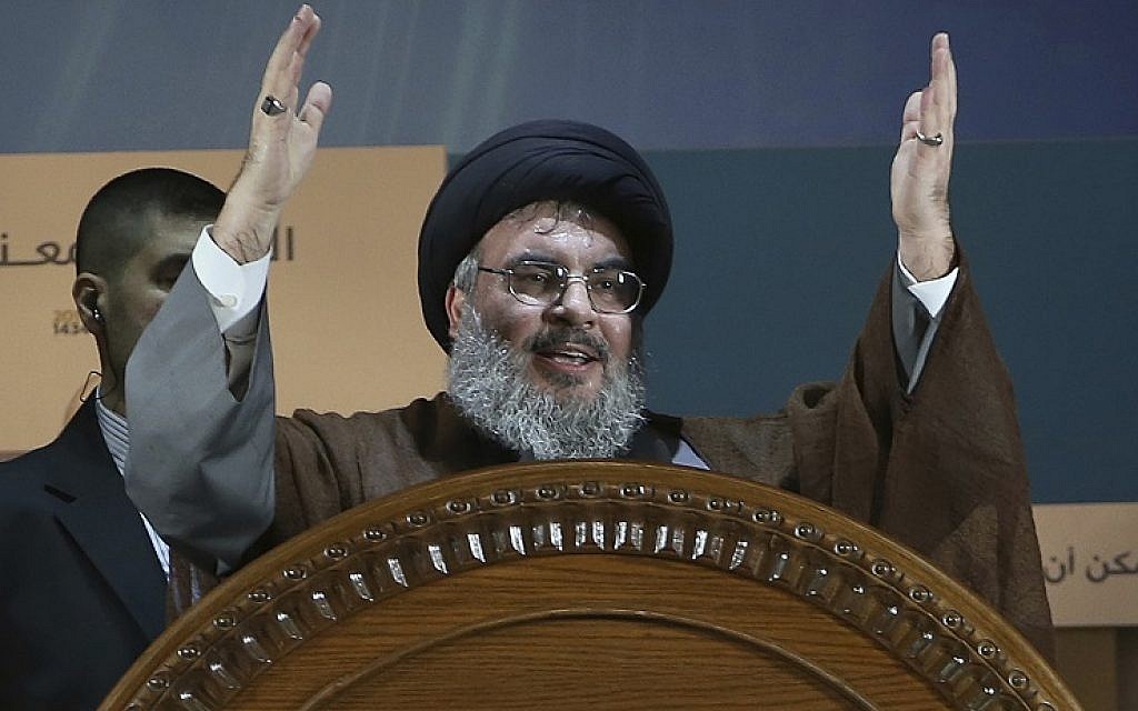 Hezbollah leader Hassan Nasrallah gestures during a rally to mark Jerusalem Day or Al-Quds Day, in a southern suburb of Beirut, Lebanon, August 2, 2013. (AP Photo/Hussein Malla, File)