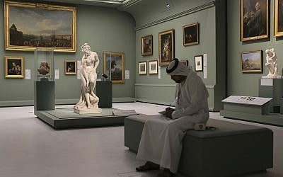 An Emirati man next to the Bather, also called Venus, statue by Christophe-Gabriel Allegrain, 1710-1795, at the Louvre Museum in Abu Dhabi, United Arab Emirates, December 19, 2017. (AP Photo/Kamran Jebreili)