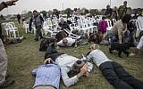 Illustrative: Israelis take cover during rocket attack siren warning in kibbutz Kfar Aza near the Israel and Gaza border, Israel, December 29, 2017. (AP/Tsafrir Abayov)