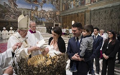 Pope Francis baptizes a child at the Vatican, January 7, 2018. (L'Osservatore Romano/Pool Photo via AP)