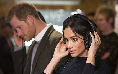 Britain's Prince Harry and his fiancee Meghan Markle during a visit to the Reprezent 107.3 FM radio station in Brixton, south London, January 9, 2018. (AP Photo/ Dominic Lipinski, Pool)
