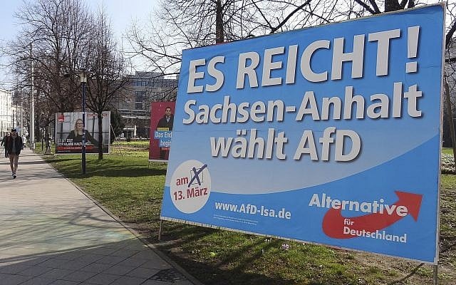 In this Wednesday, March 9, 2016 photo a man walks past a campaign poster of right-populist AfD party reading 'It's enough - Saxony-Anhalt elects AfD' in Magdeburg, Germany (AP Photo/Geir Moulson) In this Wednesday, March 9, 2016 photo a man walks past a campaign poster of right-populist AfD party reading 'It's enough - Saxony-Anhalt elects AfD' in Magdeburg, Germany (AP Photo/Geir Moulson)