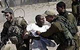 African migrants clash with Israeli soldiers after they left Holot detention center in southern Israel and walked towards the Border with Egypt near the southern Israeli Kibbutz of Nitzana, Friday, June, 27, 2014. (AP Photo/Tsafrir Abayov)