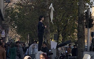 An Iranian woman waving a white scarf -- an apparent reference to so-called 'White Wednesday' protests against mandatory clothing rules for women, December 27, 2017, in Tehran, Iran. (Screencapture: YouTube)