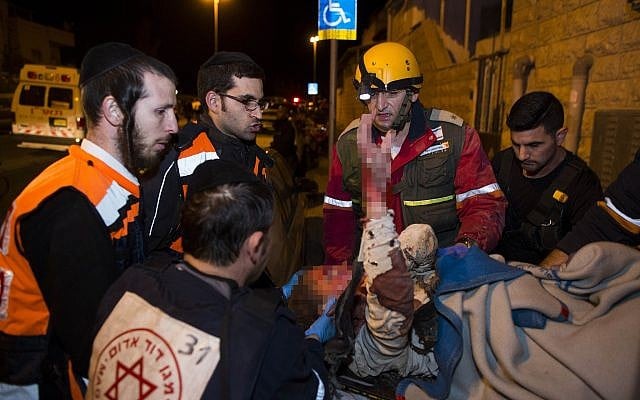 Rescue and medic personnel, including ultra-Orthodox paramedics, carrying a wounded woman at the scene of where the top floor of a building collapsed after a gas tank exploded in the Gilo neighborhood, Jerusalem, January 20, 2014. (Yonatan Sindel/Flash90) Rescue and medic personnel, including ultra-Orthodox paramedics, carrying a wounded woman at the scene of where the top floor of a building collapsed after a gas tank exploded in the Gilo neighborhood, Jerusalem, January 20, 2014. (Yonatan Sindel/Flash90)