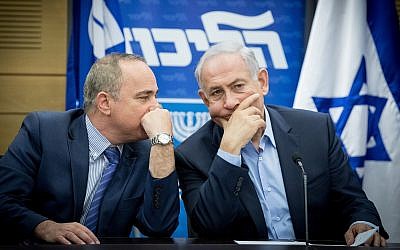 Prime Minister Benjamin Netanyahu (right) speaks with Energy Minister Yuval Steinitz during a Likud party meeting at the Knesset on May 29, 2017. (Yonatan Sindel/Flash90)
