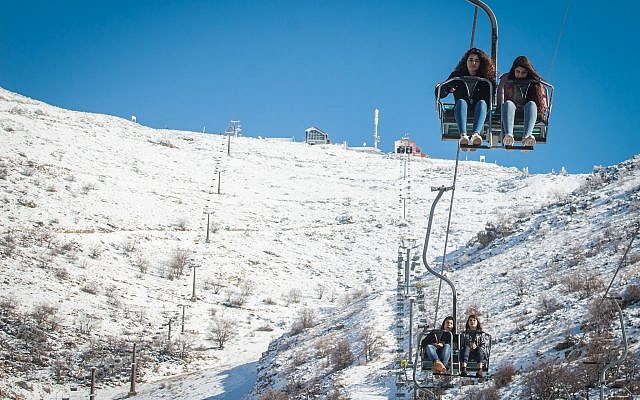People enjoy the snow at Mount Hermon ski resort, in northern Israel, on December 25, 2017. (Basel Awidat/Flash90) People enjoy the snow at Mount Hermon ski resort, in northern Israel, on December 25, 2017. (Basel Awidat/Flash90)