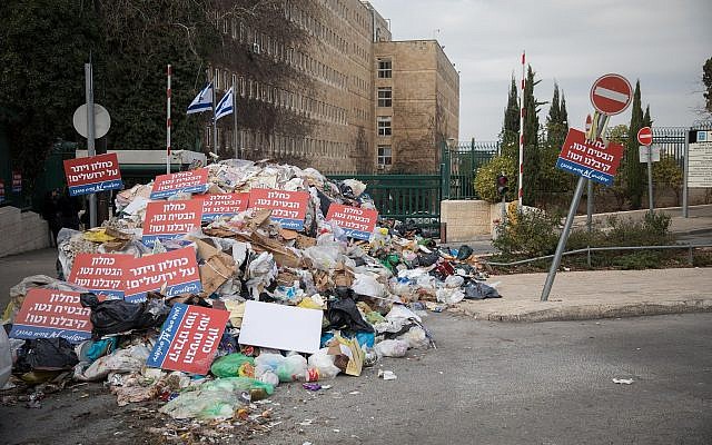 A pile of garbage left by Jerusalem city workers in front of the Finance Ministry as part of the municipality's dispute with the ministry over funding, on December 31, 2017. (Hadas Parush/Flash90) A pile of garbage left by Jerusalem city workers in front of the Finance Ministry as part of the municipality's dispute with the ministry over funding, on December 31, 2017. (Hadas Parush/Flash90)
