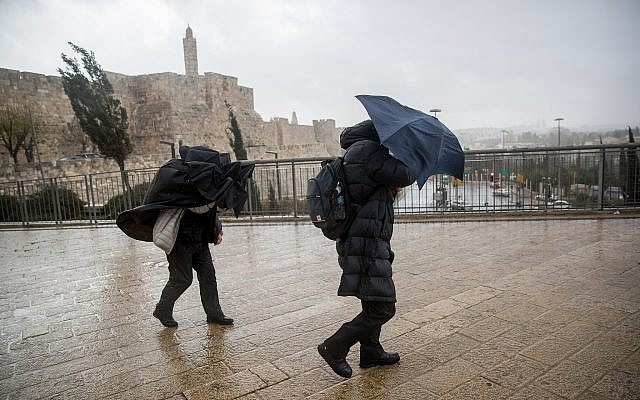 People hold umbrellas to protect themselves from the rain as they walk in Jaffa gate near the Tower of David in Jerusalem Old City, as heavy rain and wind storm hits Israel. January 05, 2018. (Yonatan Sindel/Flash90) People hold umbrellas to protect themselves from the rain as they walk in Jaffa gate near the Tower of David in Jerusalem Old City, as heavy rain and wind storm hits Israel. January 05, 2018. (Yonatan Sindel/Flash90)