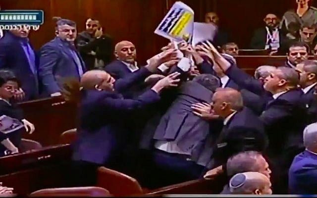 Knesset ushers eject lawmakers from the Joint (Arab) List from the plenum after they hold up signs reading "Jerusalem is the capital of Palestine" at the start of US Vice President Mike Pence's speech on January 22, 2018. (Screen capture/Twitter)