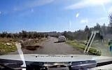 Still from video of police car rescuing tourist vehicle that strayed into West Bank Arab village of Teqoa on January 9, 2018. (Screen capture: Hadashot news)