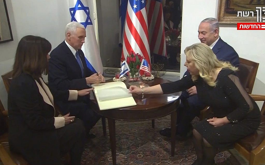 US Vice President Mike Pence and Second Lady Karen Pence sign the guestbook at the prime minister's residence in Jerusalem, across from Prime Minister Benjamin Netanyahu and his wife, Sara (screen capture: Channel 2)
