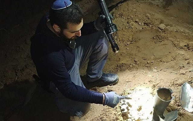 A police officer inspects a rocket that was fired at the Eshkol region of southern Israel by terrorists in the Gaza Strip on January 1, 2018. (Israel Police) A police officer inspects a rocket that was fired at the Eshkol region of southern Israel by terrorists in the Gaza Strip on January 1, 2018. (Israel Police)