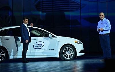 Prof. Amnon Shashua, left, senior VP at Intel and CEO of Mobileye, arrived on stage at CES in the backseat of an autonomous car during the preshow keynote of Intel's CEO Brian Krzanich, right, in January 2018. (Walden Kirsch/Intel Corp)
