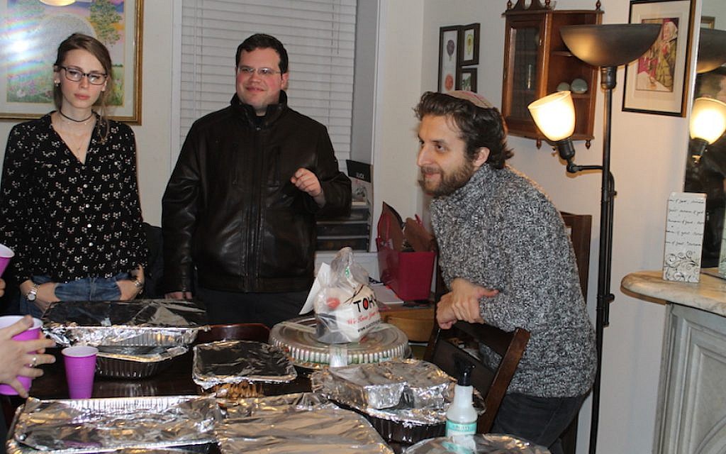 Rabbi Avram Mlotek, right, welcomes Samantha Bowser and Jared Gimbel to a Base Hillel event at his apartment in New York City, January 16. 2018. (Ben Sales/JTA) Rabbi Avram Mlotek, right, welcomes Samantha Bowser and Jared Gimbel to a Base Hillel event at his apartment in New York City, January 16. 2018. (Ben Sales/JTA)