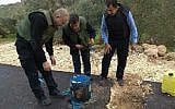 Palestinian Authority security forces inspect a roadside bomb found in the West Bank on Saturday, January 27, 2018. (Ma'an news agency)