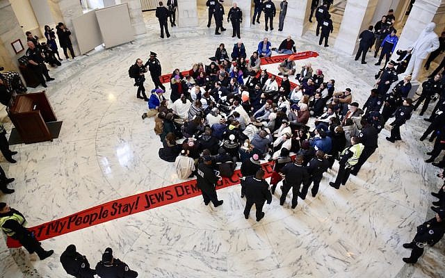 Jewish protesters link arms in a Senate office building asking for protections for undocumented immigrants who arrived as children, Jan. 17 2018. (Religious Action Center of Reform Judaism via JTA) Jewish protesters link arms in a Senate office building asking for protections for undocumented immigrants who arrived as children, Jan. 17 2018. (Religious Action Center of Reform Judaism via JTA)