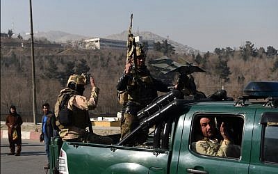 Afghan security personnel gesture as they leave the Intercontinental Hotel after an attack in Kabul,  January 21, 2018.  (AFP PHOTO / WAKIL KOHSAR)
