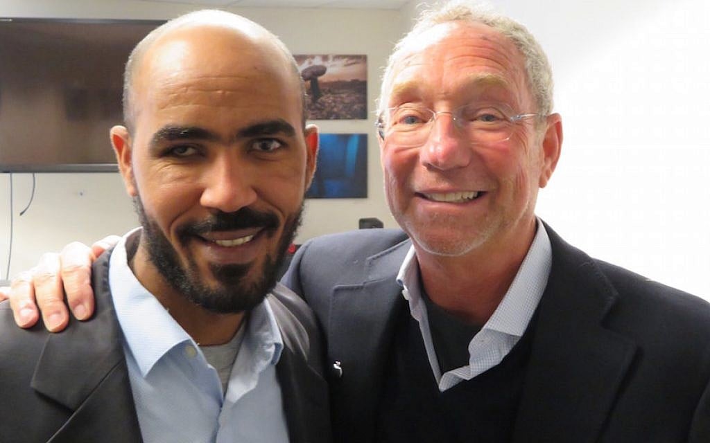 Yikealo Beyene, left, an Eritrean refugee, with Joey Low, an American Jewish philanthropist, in Washington, DC, Jan. 8, 2018. (Ron Kampeas via JTA) Yikealo Beyene, left, an Eritrean refugee, with Joey Low, an American Jewish philanthropist, in Washington, DC, Jan. 8, 2018. (Ron Kampeas via JTA)
