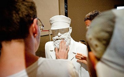 Visitors to the Jewish Museum and Tolerance Center in Moscow viewing one of the many sculptures there depicting the history of Jewish life in Russia, May 21, 2013. (Courtesy of the Jewish Museum and Tolerance Center/via JTA)