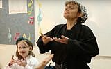 Jill Shames, director of Training and Certification at Kids Kicking Cancer, teaching children breathing techniques (YouTube screenshot)