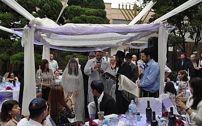 Rabbi Osher Litzman, under the canopy in black, performing a Jewish wedding in Seoul, South Korea. (Courtesy of Chabad of South Korea/via JTA)
