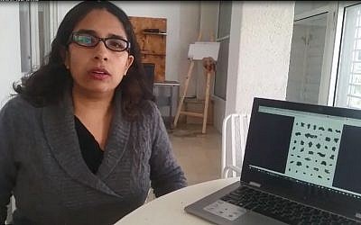 Dr. Eshbal Ratson with an image of the newly deciphered Dead Sea Scroll. (University of Haifa)