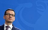 Polish Prime Minister Mateusz Morawiecki gives a press conference with the German Chancellor on February 16, 2018 at the Chancellery in Berlin. (AFP Photo/John MacDougall)