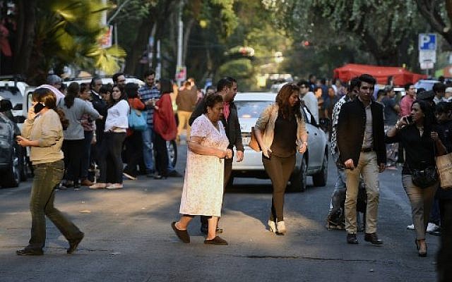 Peoplerush out into the streets during a powerful earthquake in Mexico City on February 16, 2018.
Mexico's National Seismological Service put the magnitude of the quake at 7.0, and seismic monitor network Sky Alert said the quake was felt across the states of Guerrero, Oaxaca and Puebla. (AFP PHOTO / ALFREDO ESTRELLA) Peoplerush out into the streets during a powerful earthquake in Mexico City on February 16, 2018.
Mexico's National Seismological Service put the magnitude of the quake at 7.0, and seismic monitor network Sky Alert said the quake was felt across the states of Guerrero, Oaxaca and Puebla. (AFP PHOTO / ALFREDO ESTRELLA)