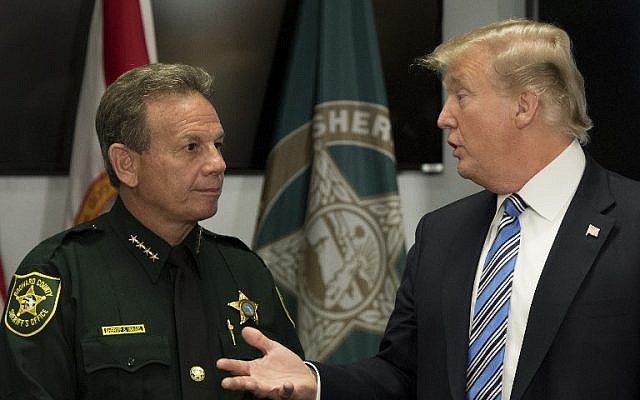 US President Donald Trump (R) speaks with Broward County Sheriff Scott Israel (L) while visiting first responders at Broward County Sheriff's Office in Pompano Beach, Florida, on February 16, 2018, three days after a mass shooting that claimed 17 lives at a nearby high school. ( AFP PHOTO / JIM WATSON) US President Donald Trump (R) speaks with Broward County Sheriff Scott Israel (L) while visiting first responders at Broward County Sheriff's Office in Pompano Beach, Florida, on February 16, 2018, three days after a mass shooting that claimed 17 lives at a nearby high school. ( AFP PHOTO / JIM WATSON)