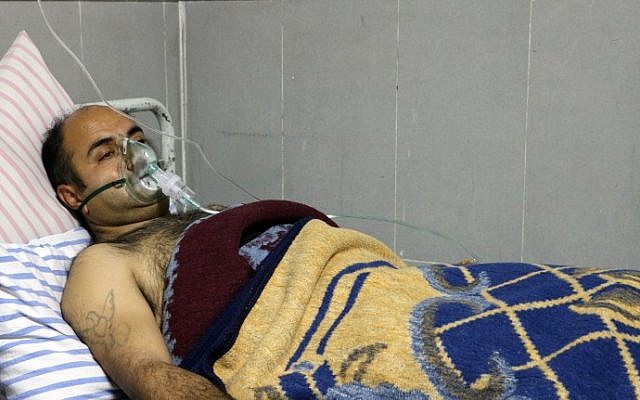 A picture taken on February 16, 2018, shows a Syrian man receiving treatment at a hospital in the town of Afrin.
Six men were treated for breathing difficulties in the main hospital in Afrin after shelling by a Turkish-led offensive on their village, the general director of the Afrin hospital said. (AFP PHOTO / Ahmad Shafie BILAL) A picture taken on February 16, 2018, shows a Syrian man receiving treatment at a hospital in the town of Afrin.
Six men were treated for breathing difficulties in the main hospital in Afrin after shelling by a Turkish-led offensive on their village, the general director of the Afrin hospital said. (AFP PHOTO / Ahmad Shafie BILAL)